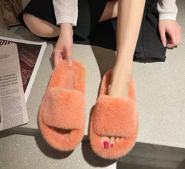 Soft and fluffy women's peach-colored slippers